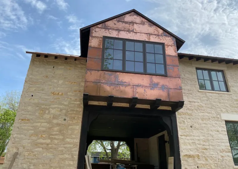 Copper metal panel facade on a stone building for Skylight Installation in Terrell Hills